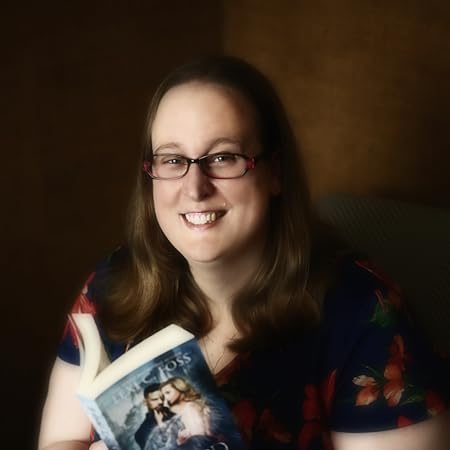 Photo of author Lexi C. Floss looking into the camera while holding a book.